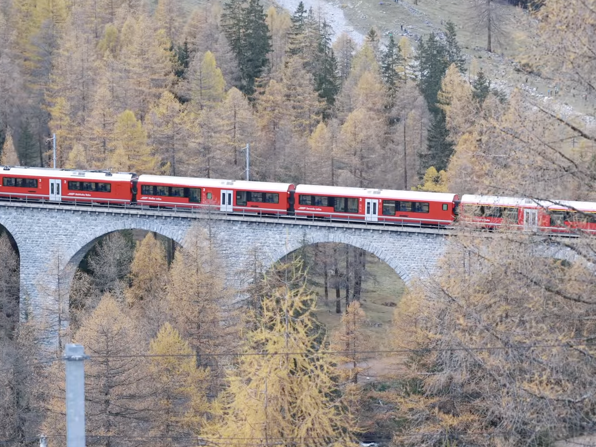 Swiss train crossing bridge in Alps