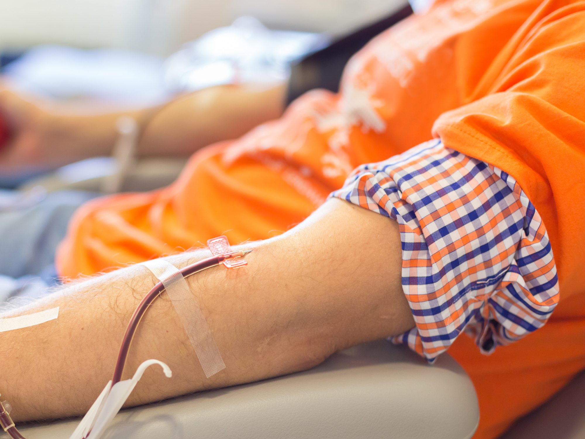 Blood donor's arm with donation in progress