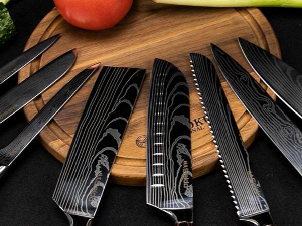 A lineup of knives on a round wood cutting board