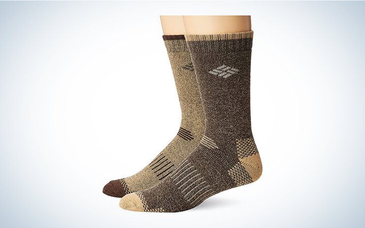  A pair of brown and green hiking socks on a blue and white background