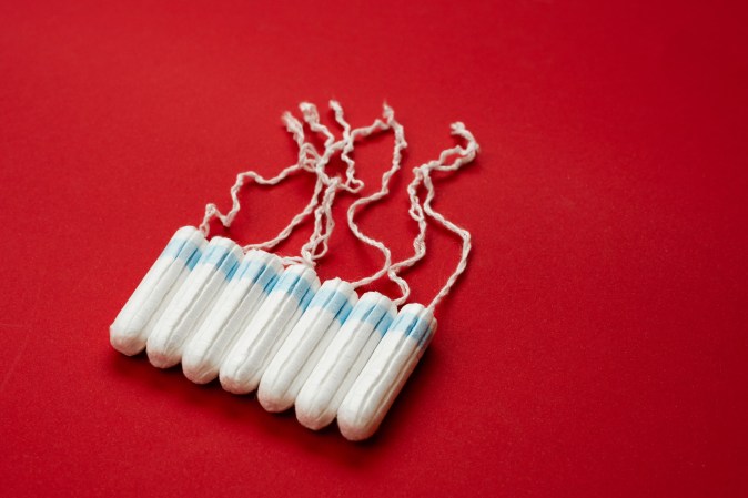 Eight tampons on a red background