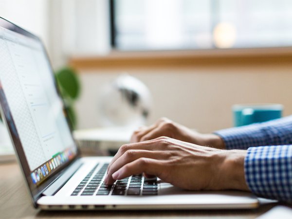 A person typing on a laptop