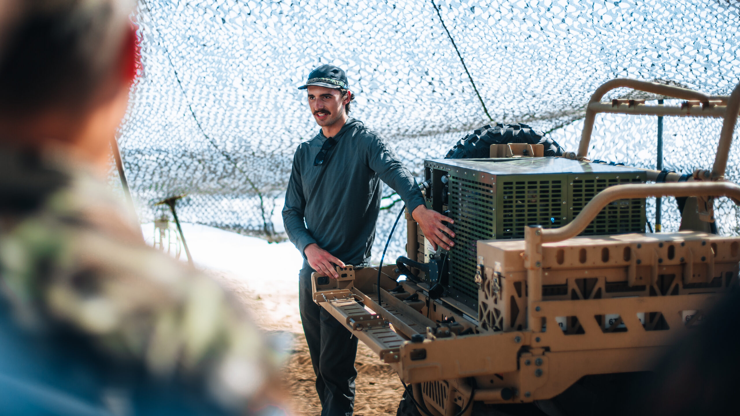 A representative of U.S. Indo-Pacific Command Logistics Science and Technology briefs distinguished visitors on the Atmospheric Portable-water Sustainment Unit and Lightweight Water Purification System at Marine Corps Base Hawaii,