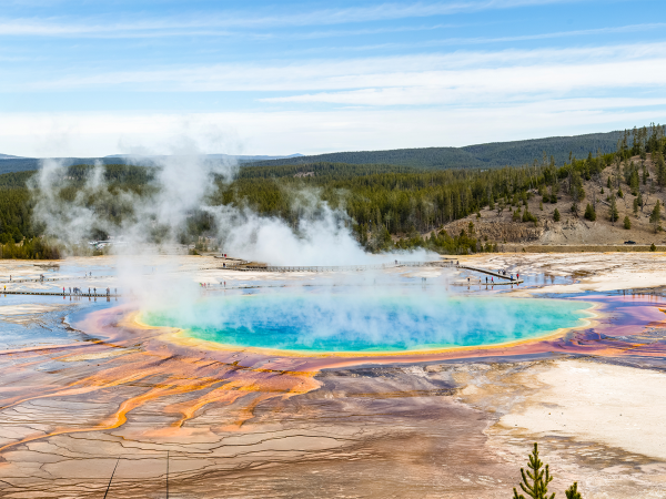 The view of a colorful lake and steam from Yellowstone's Grand Prismatic Overlook Trail.