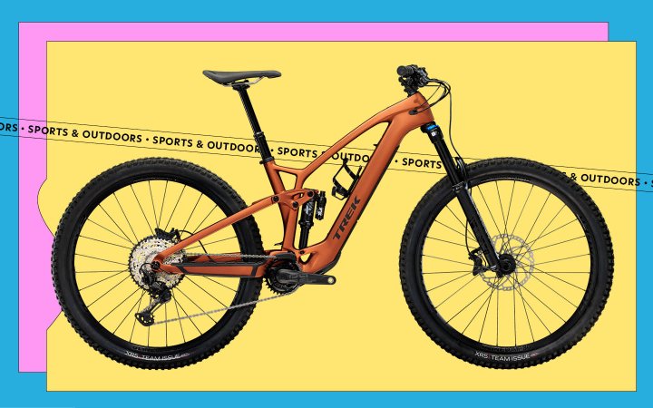  Am orange Trek Bikes Fuel EXE ebike on a yellow, pink, and blue background