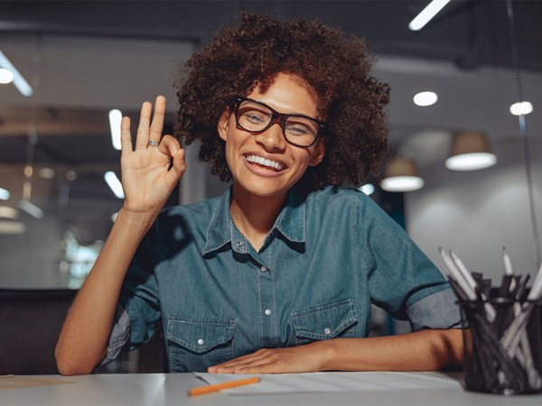 A person uses American Sign Language to the camera