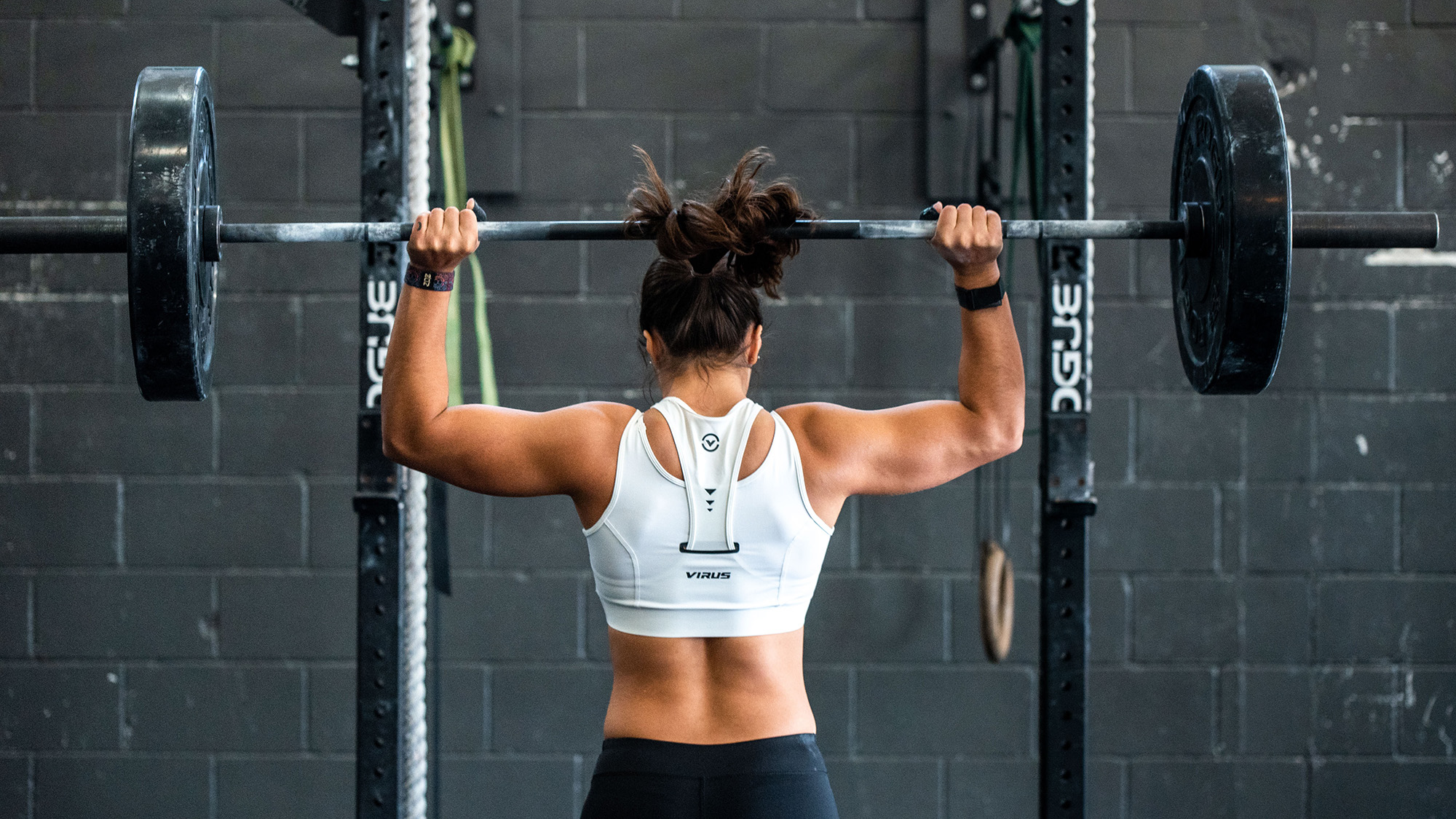 person-lifting-weights-at-the-gym