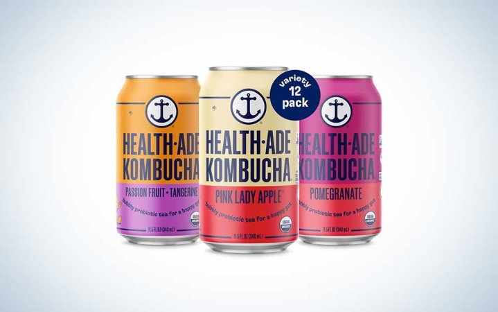  Three cans of Health-ade kombucha on a plain background.