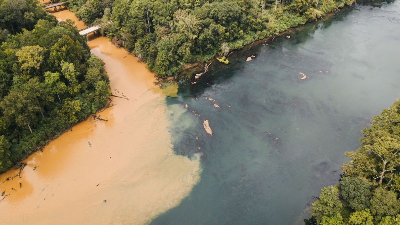 Sediment running into a river in Alabama from a solar farm construction site. Aerial view.