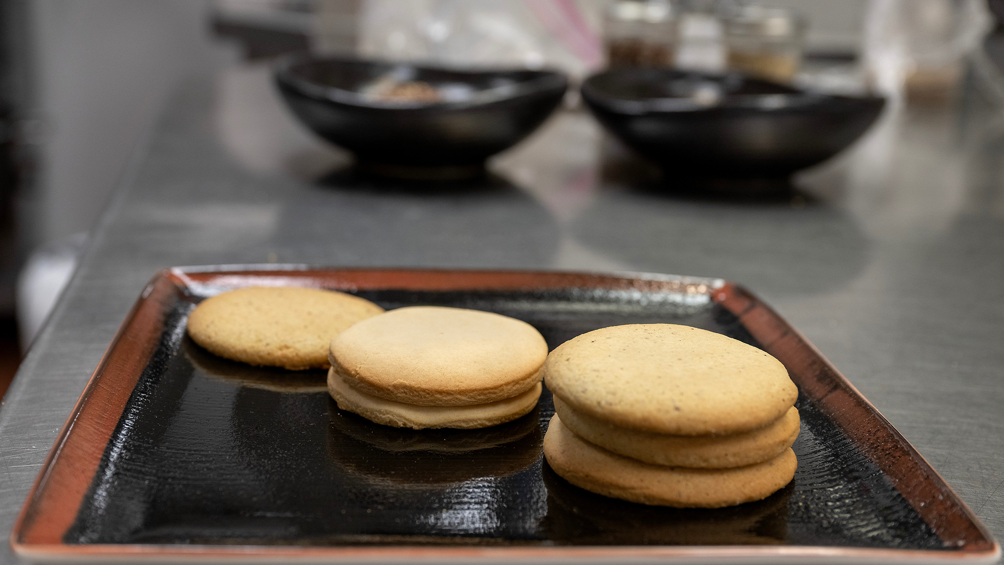 Sugar cookies baked with quinoa flour on a cookie sheet in a kitchen.