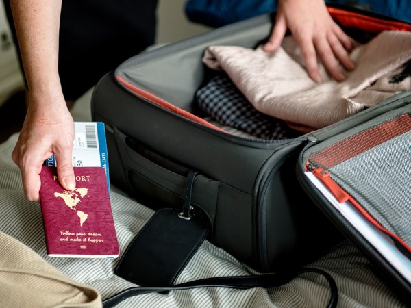 A person packs their luggage