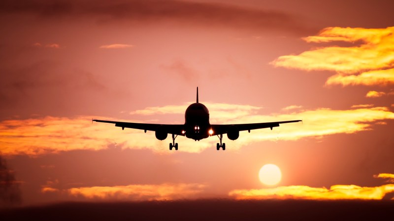 Plane against sunset sky.