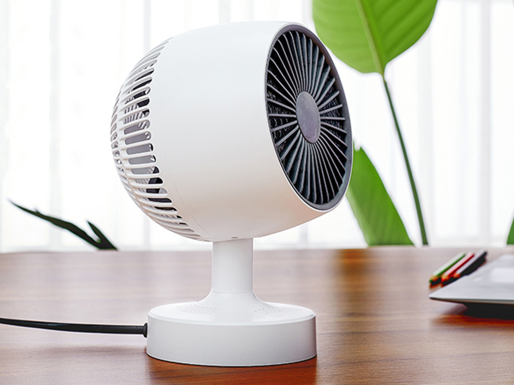 A desktop heater sitting on a wooden desk