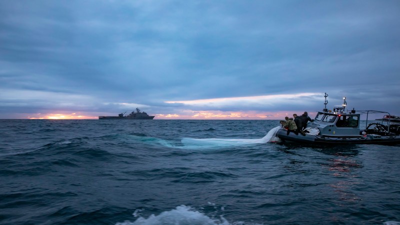 Sailors assigned to Explosive Ordnance Disposal Group 2 recover a high-altitude surveillance balloon off the coast of Myrtle Beach, South Carolina.