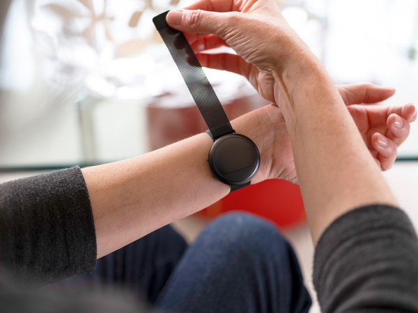 A person puts on an Embr Wave 2 Rechargeable Thermal Wristband