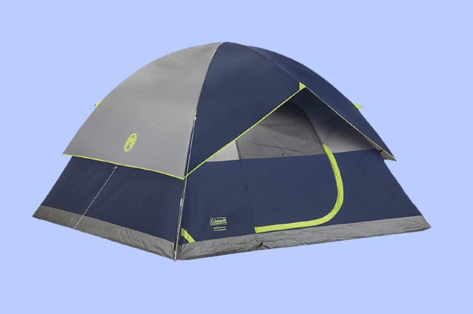 A Coleman camping tent on a periwinkle background