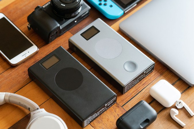 Two power banks against a wood table.