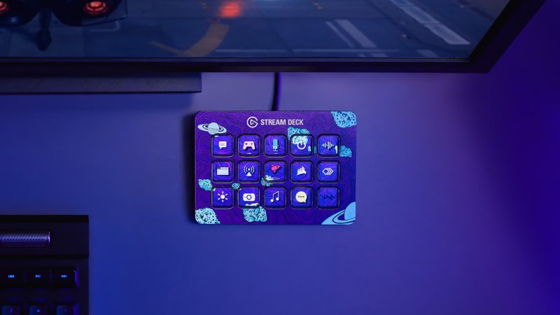  An Elgato Stream Deck under a wall-mounted TV, in a room with blue lighting.