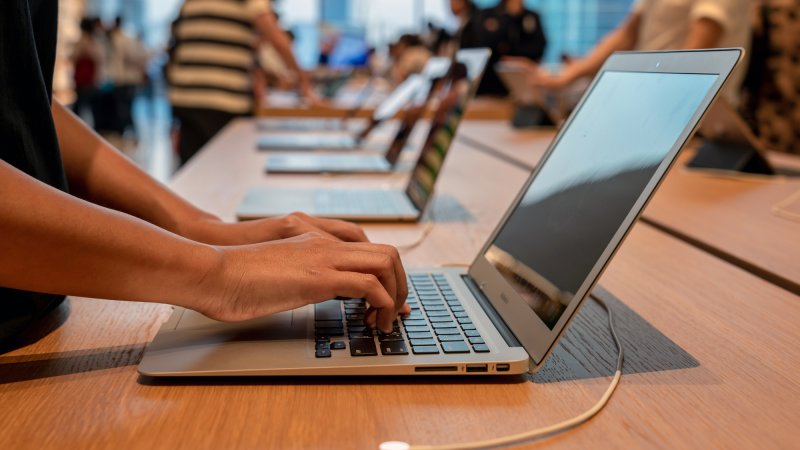 Close up of customer trying out MacBook at Apple Store