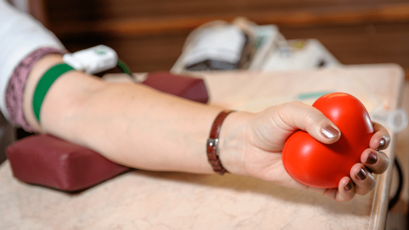 An donor relaxes their arm after donating blood.