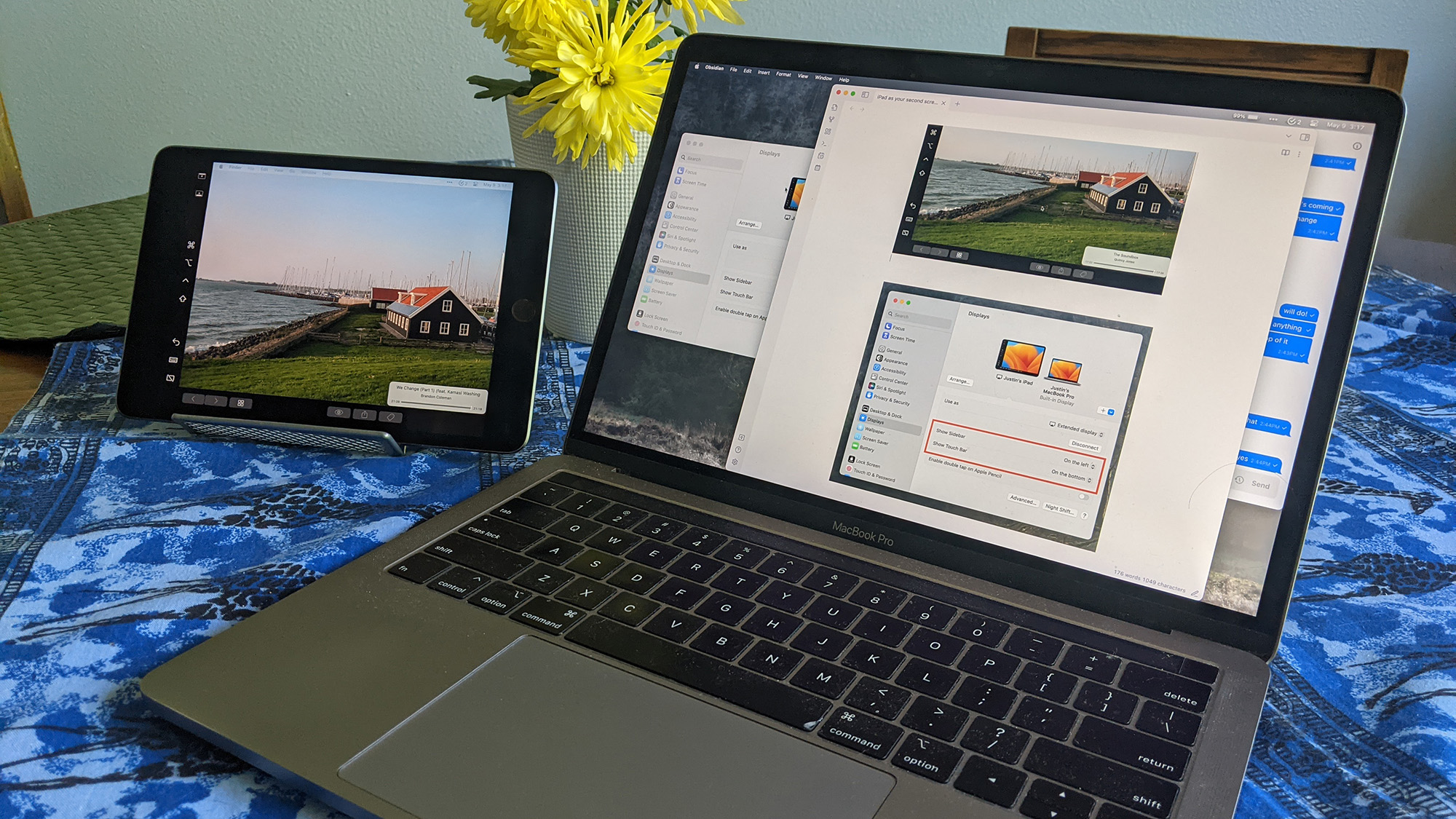 A MacBook sitting next to an iPad used as a second screen.