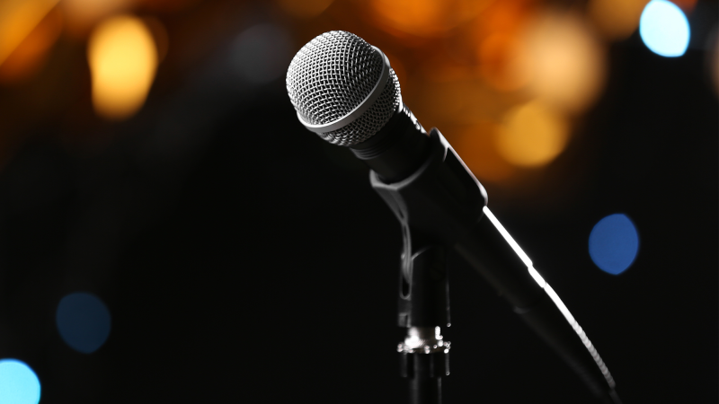 A microphone on a dark stage.