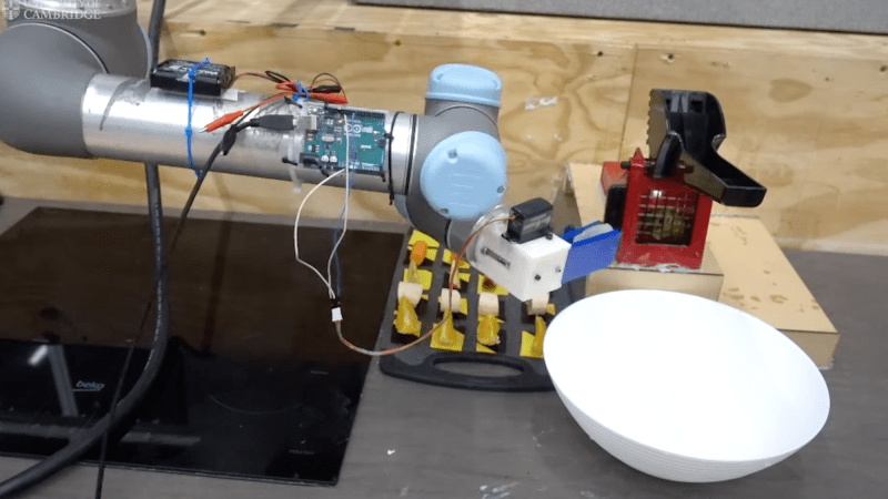 Robot arm assembling salad from ingredients