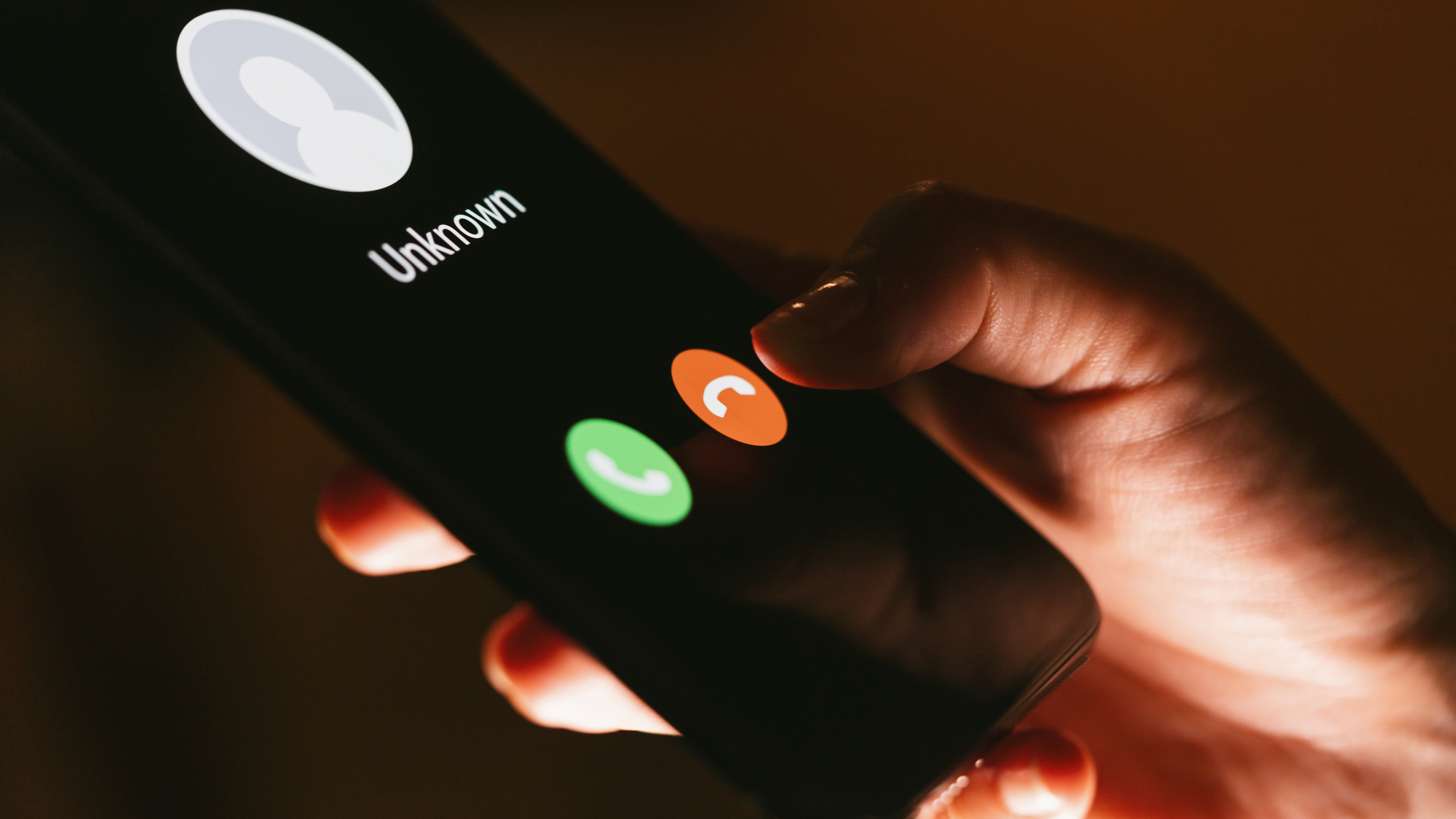 Close up of woman's hands with smartphone and unknown incoming phone call on it