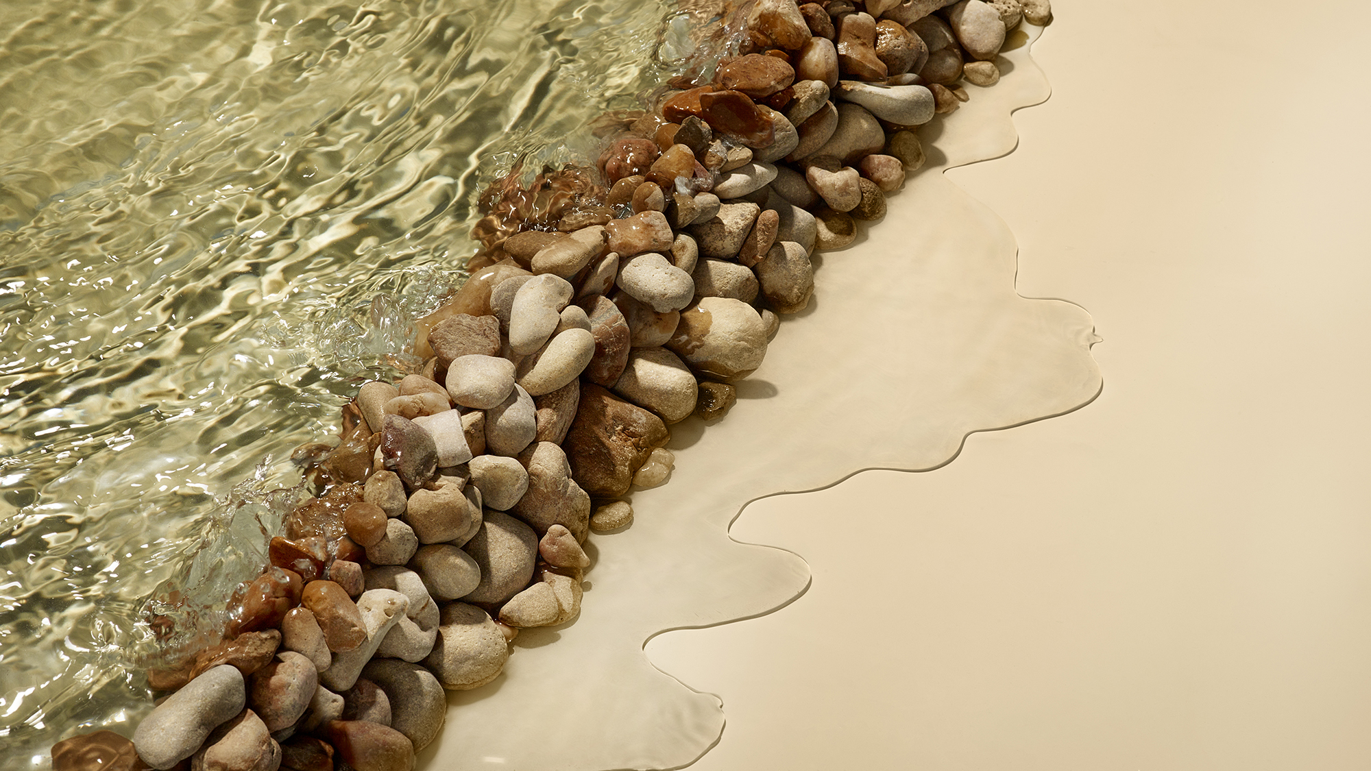 Line of rocks letting water leak through to represent a different approach to water management during drought