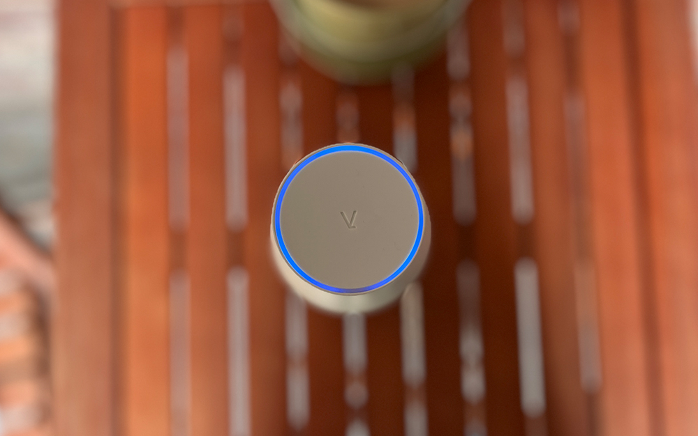 A LARQ water bottle sitting on a wooden table