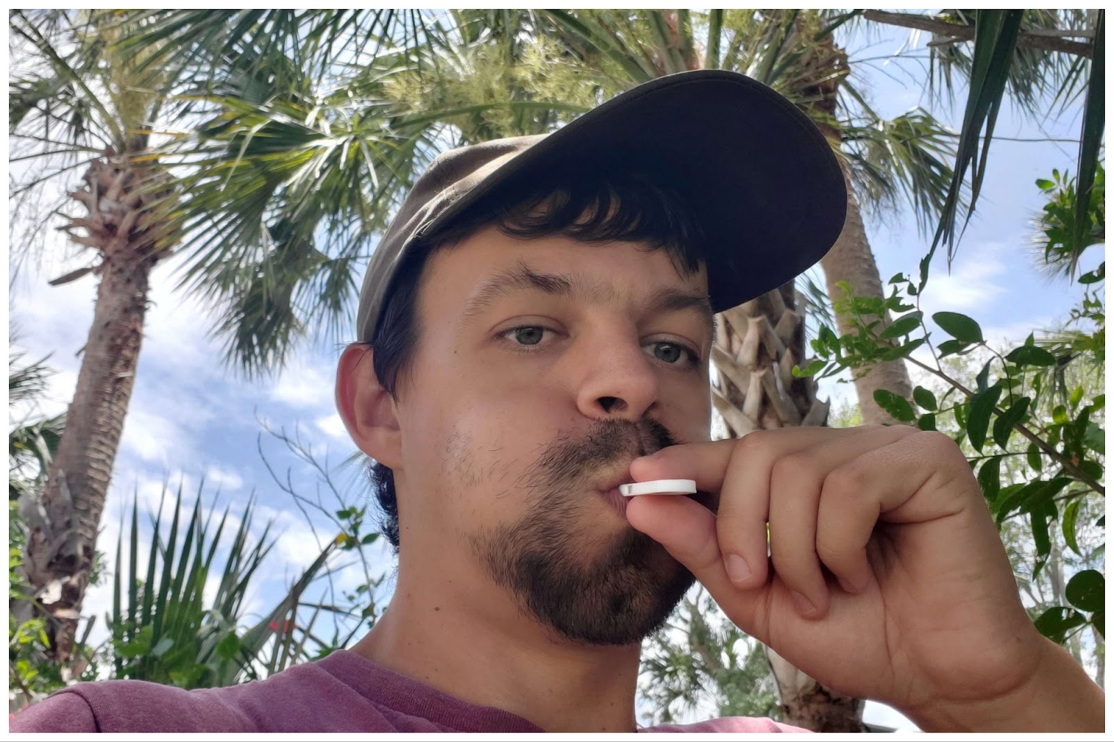 John Alexander outside blowing a coconut white whistle he 3D printed with the Toybox