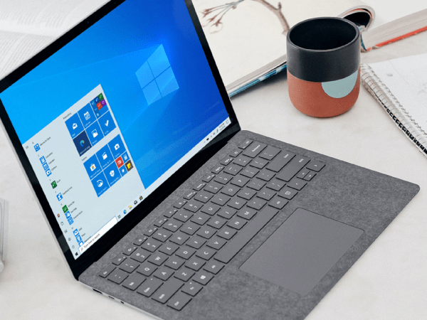 A Windows 11 Pro laptop on a white desk