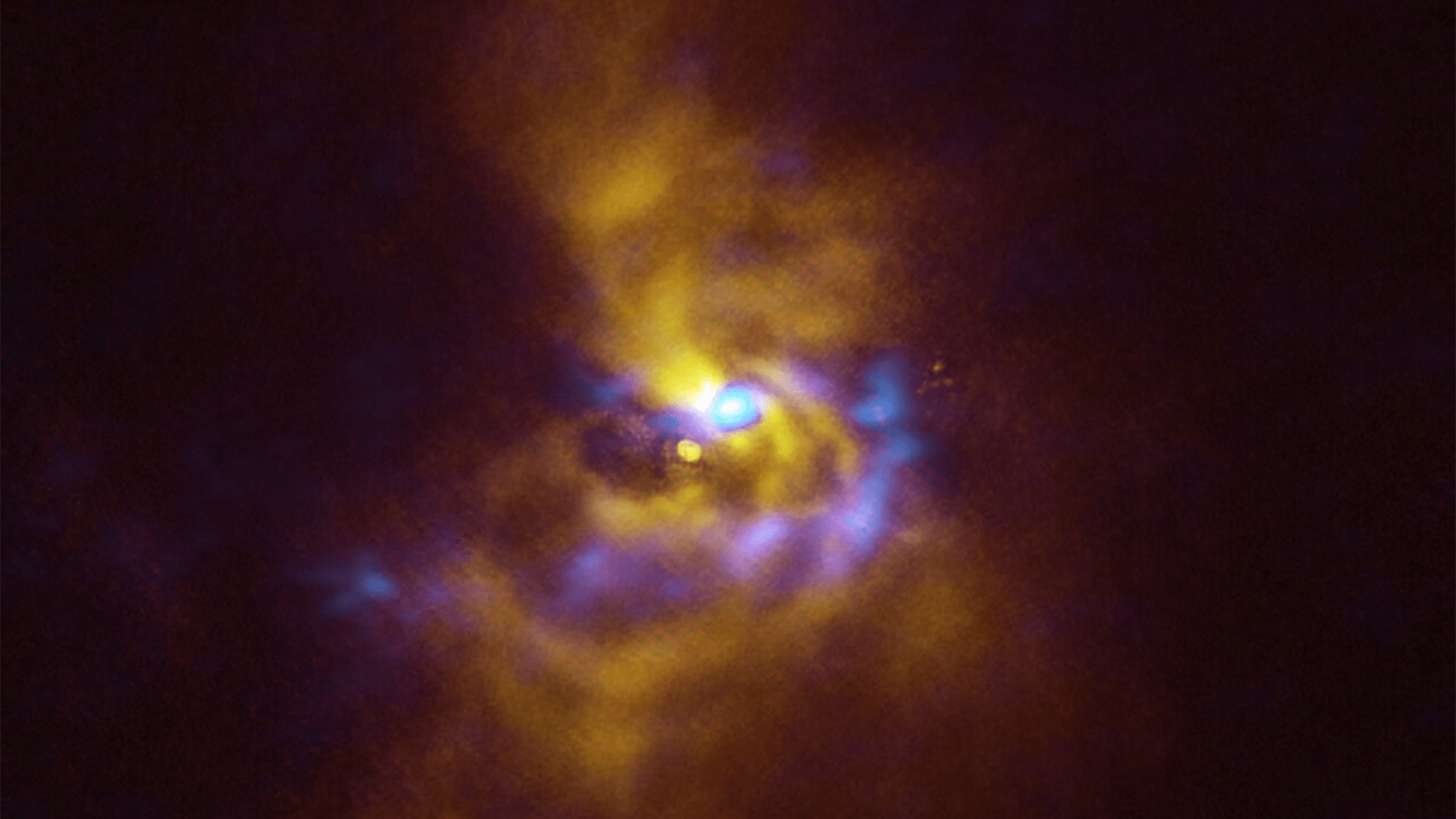 A young star named V960 Mon is at the center, with dusty material with the potential to form planets surrounding it. V960 Mon is located over 5000 light-years away from Earth in the constellation Monoceros.