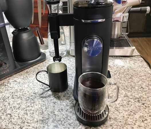  Ninja Pods & Grounds Single-Serve Coffee Maker drip coffee maker on a crowded kitchen counter