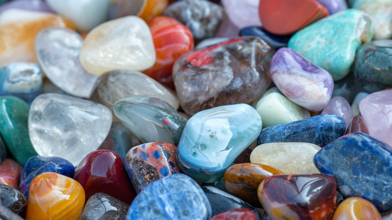 Colorful gemstones nearly arranged. Iron content correlates to the signature purple hue in amethysts and elements including chromium, vanadium, and copper also impact a gem’s color.