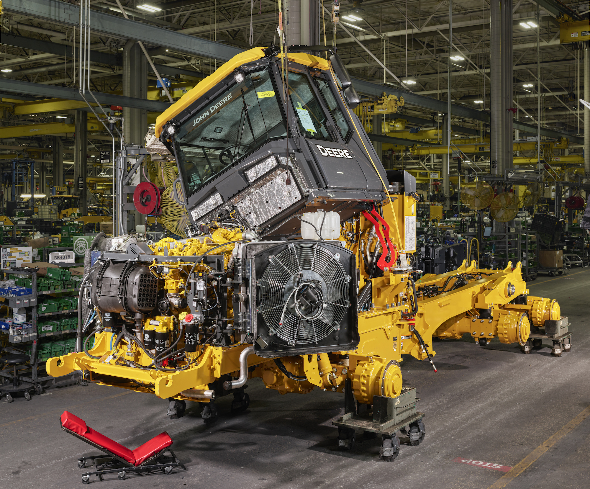 a john deere dump truck under construction in a factory