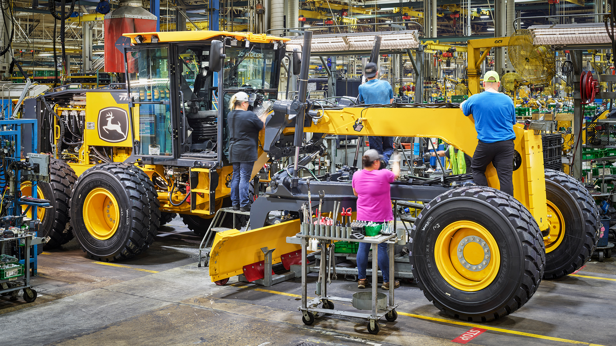 a john deere motor grader in a factory