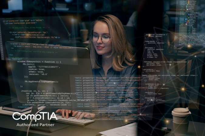 A person sitting and coding at a computer