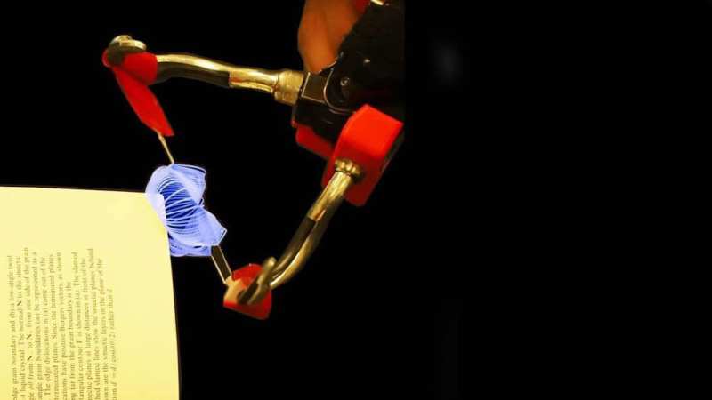 Soft robot gripper turning a book page