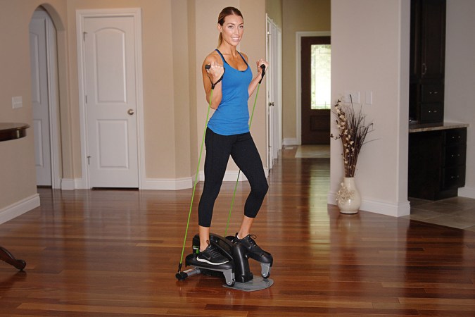 A person using a strider in their living room to exercise