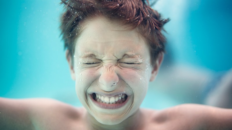 Portrait of a little boy underwater crying