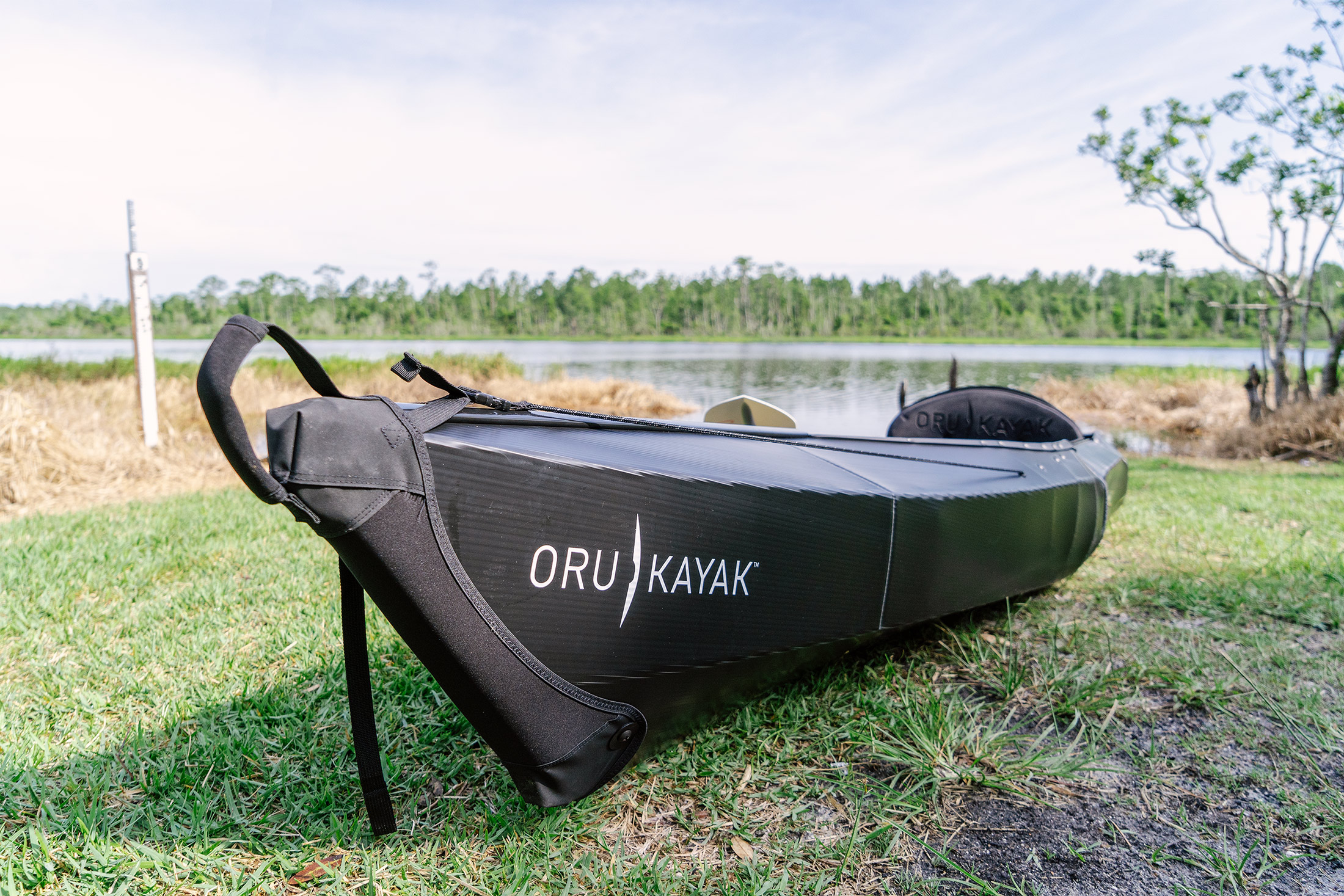 The Oru kayak on a grassy shoreline