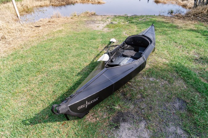  Oru Beach LT Sport kayak on a grassy shoreline