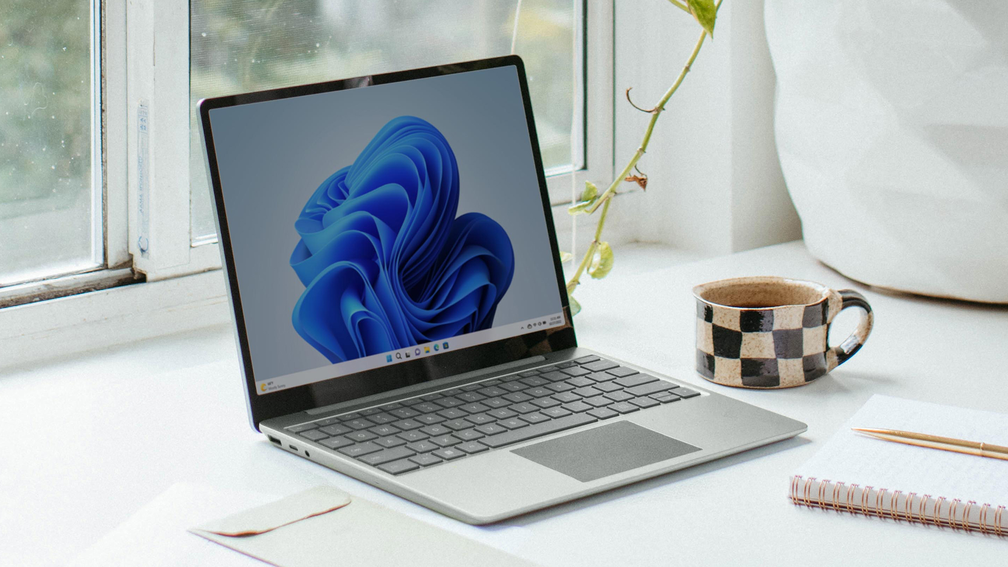 A laptop on a desk, probably with Apple apps for Windows installed