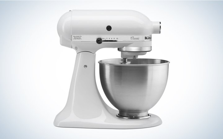  A white KitchenAid classic mixer on a blue and white background