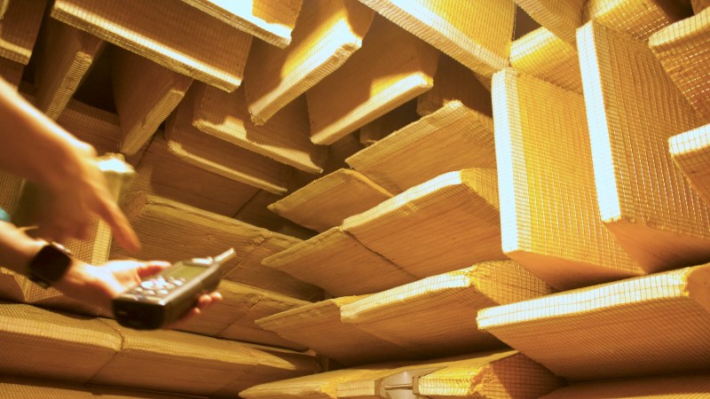 wedges in the anechoic chamber and a hand holding a sound level meter