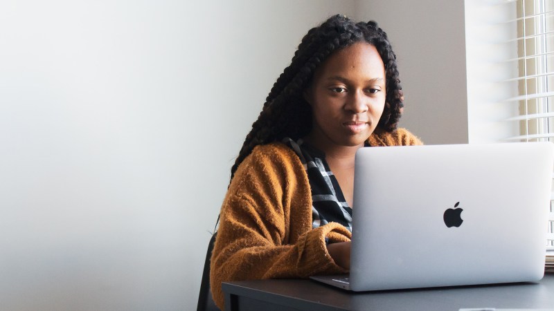 Person sitting at desk, looking at laptop, probably transferring their bookmarks from Chrome to Edge.