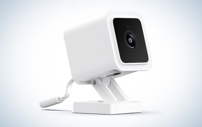 A white WYZE Cam v3 against a white background with a gray gradient.