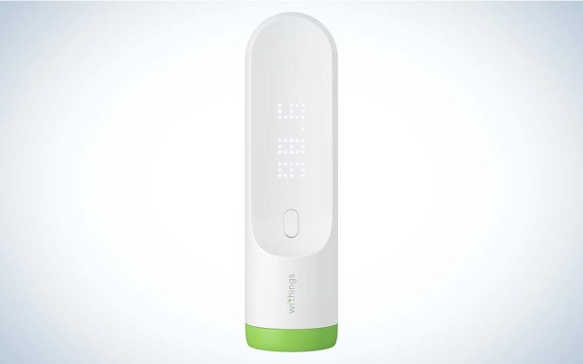 A white Withings Thermo Smart Digital Thermometer with a green ring around the bottom against a plain background.