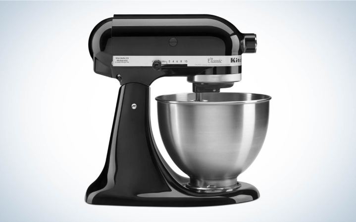  A KitchenAid black stand mixer with a silver bowl in profile on a plain background.